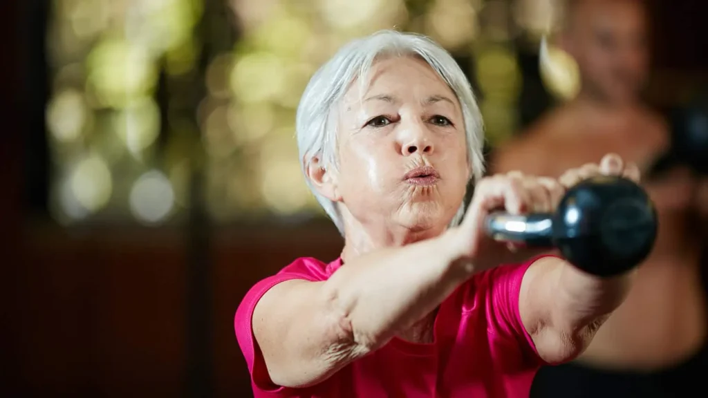Toning Arms Without the Bulk: Is It Achievable? 1 Woman doing resistance band exercises for toned arms Weymouth
