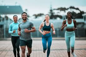 Sculpting Sleek Arms: The Essential Role of Cardio in Toning Without Bulking Up 3 image of people running to incorporate cardio Weymouth exercise into their life to help tone arms and body.