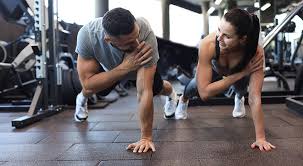 Image of man and woman doing Cardio Weymouth to tone their arms. 